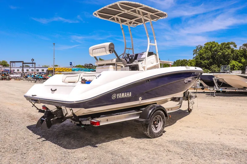 Slide: The Image of 2017 Yamaha Boats 190 FSH Sport on trailer, parked outdoors under clear blue sky. - 3