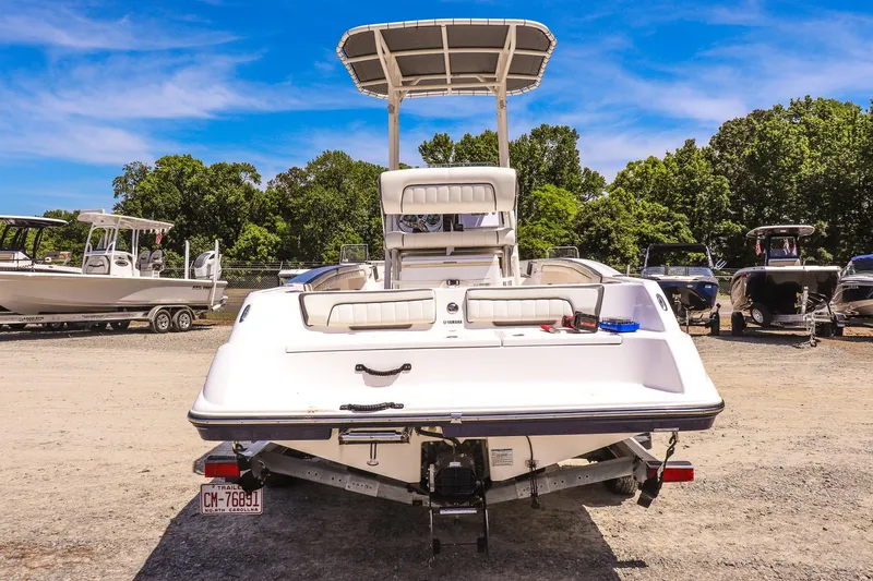 Slide: The Image of 2017 Yamaha Boats 190 FSH Sport on trailer, parked outdoors under clear blue sky. - 4