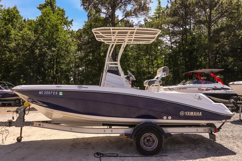 Slide: The Image of 2017 Yamaha Boats 190 FSH Sport on trailer, surrounded by trees and other boats. - 6