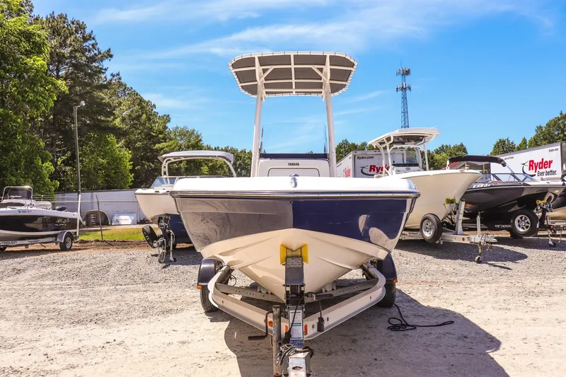 Slide: The Image of 2017 Yamaha Boats 190 FSH Sport on trailer, surrounded by other boats, under clear blue sky. - 8