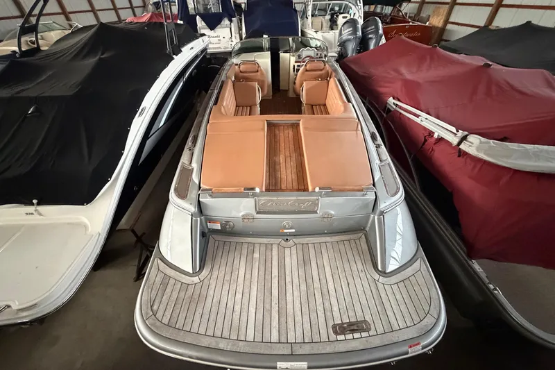 Slide: The Image of 2013 Chris-Craft Launch 25 boat with tan interior, docked in storage. - 11