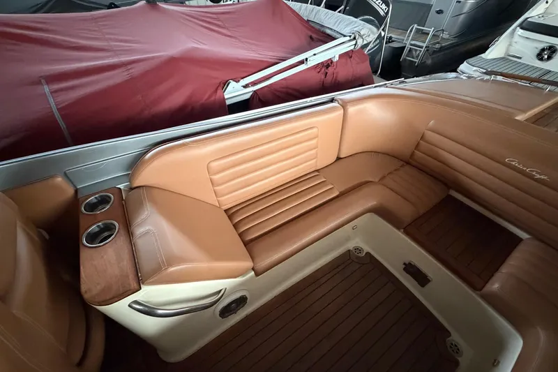Slide: The Image of Luxurious 2013 Chris-Craft Launch 25 boat interior with tan leather seating and wood accents. - 14