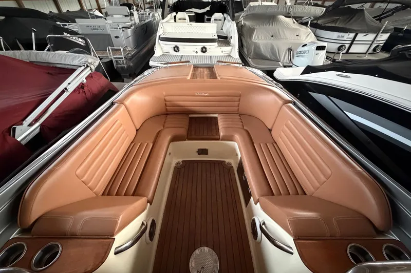 Slide: The Image of 2013 Chris-Craft Launch 25 boat interior with tan leather seating and wooden flooring. - 16