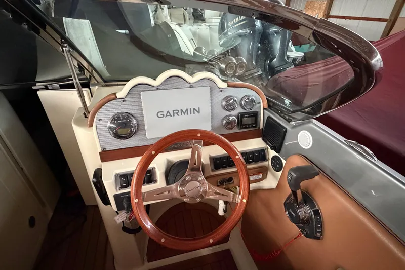 Slide: The Image of 2013 Chris-Craft Launch 25 dashboard with Garmin navigation and wooden steering wheel. - 17