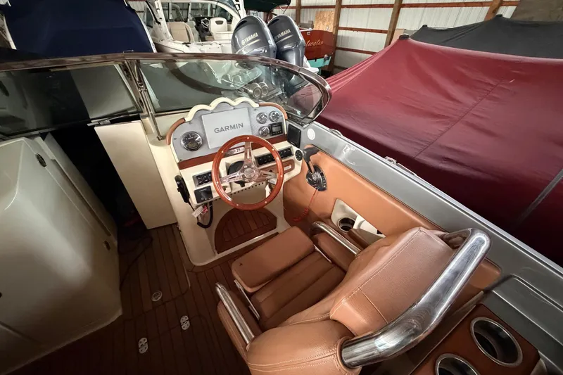 Slide: The Image of 2013 Chris-Craft Launch 25 boat interior with Garmin navigation system and leather seating. - 19