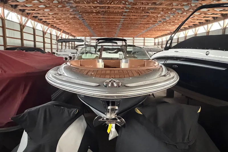 Slide: The Image of 2013 Chris-Craft Launch 25 boat in storage, showcasing elegant design and craftsmanship. - 2