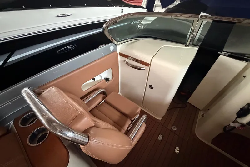 Slide: The Image of 2013 Chris-Craft Launch 25 interior with brown leather seating and sleek design elements. - 20