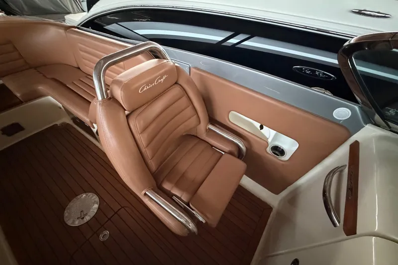Slide: The Image of 2013 Chris-Craft Launch 25 boat interior with brown leather seating and wood accents. - 21