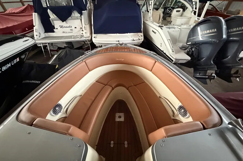 Slide: The Image of 2013 Chris-Craft Launch 25 boat interior with tan leather seating in storage. - 23