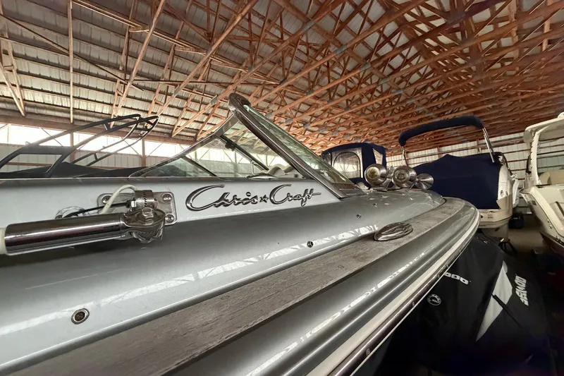 Slide: The Image of 2013 Chris-Craft Launch 25 boat in storage, showcasing sleek design and logo. - 5