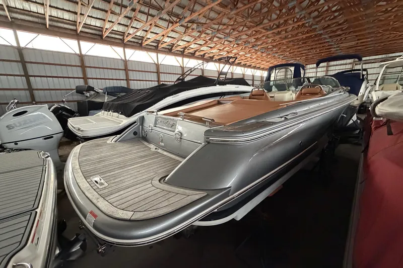 Slide: The Image of 2013 Chris-Craft Launch 25 boat in storage, showcasing sleek design and luxury features. - 7