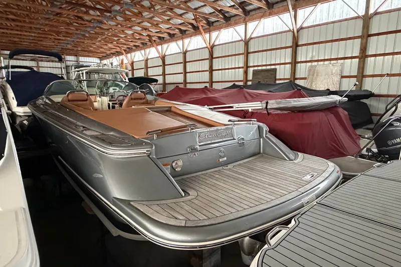 Slide: The Image of 2013 Chris-Craft Launch 25 boat in storage, showcasing sleek design and luxury features. - 8