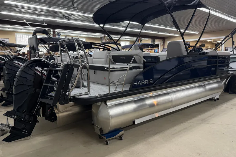 Slide: The Image of 2026 Harris Cruiser 210 SLDH pontoon boat with dual Mercury engines in showroom. - 12
