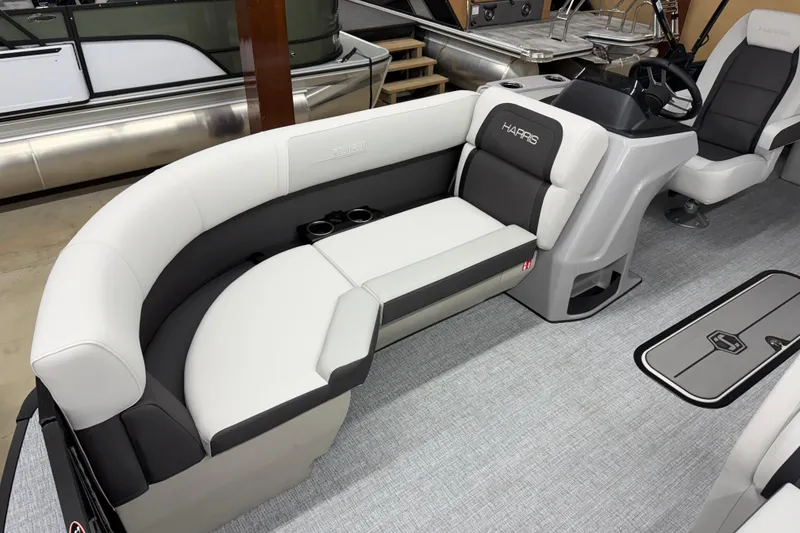 Slide: The Image of 2026 Harris Cruiser 210 SLDH pontoon boat interior with plush seating and modern helm. - 4