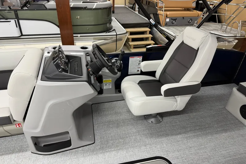 Slide: The Image of 2026 Harris Cruiser 210 SLDH boat interior with modern helm and comfortable captain's chair. - 6