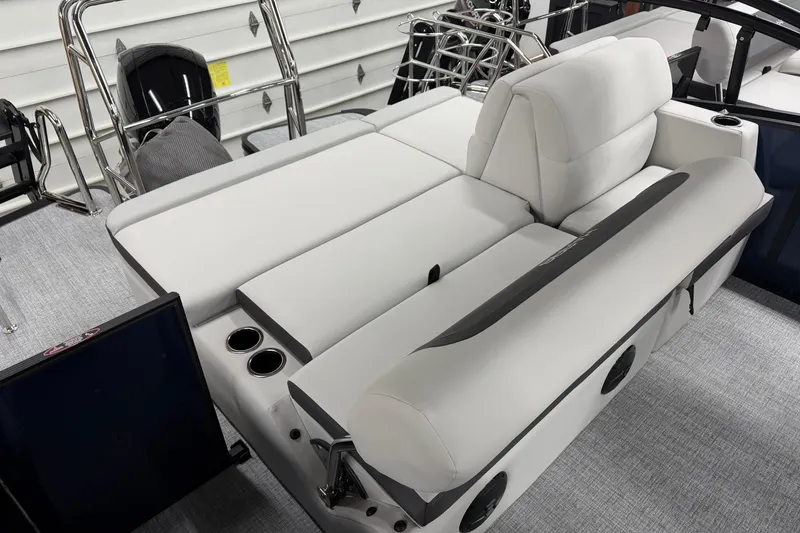 Slide: The Image of 2026 Harris Cruiser 210 SLDH boat interior with plush seating and cup holders. - 9