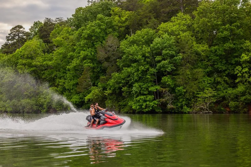 Slide: The Image of 2026 Yamaha WaveRunner FX Cruiser HO speeding on a scenic lake with lush green trees. - 18