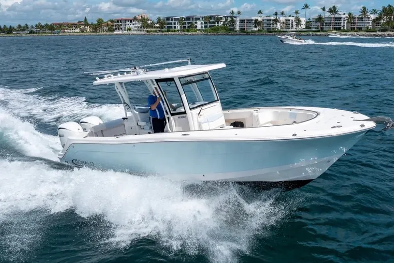 Slide: The Image of 2023 Robalo R302 Center Console boat cruising on open water. - 11