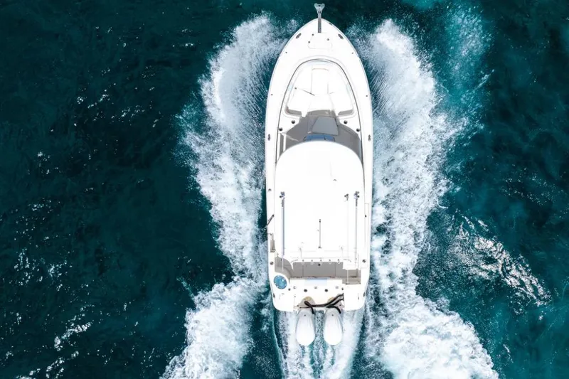 Slide: The Image of 2023 Robalo R302 Center Console boat cruising on open blue water. - 12