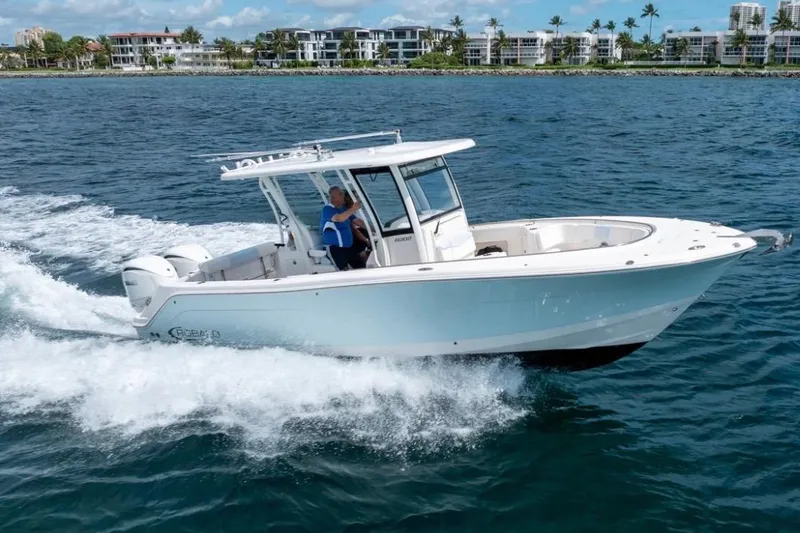 Slide: The Image of 2023 Robalo R302 Center Console boat cruising on open water. - 13