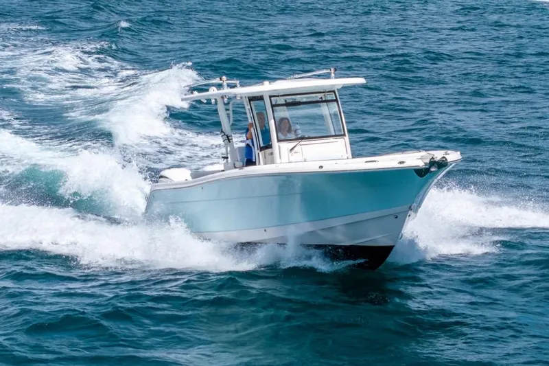 Slide: The Image of 2023 Robalo R302 Center Console boat cruising on open water. - 14