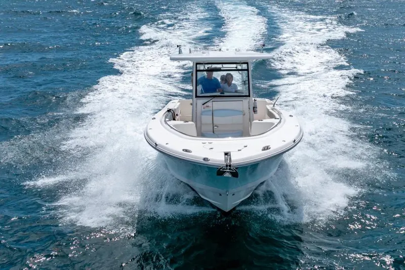 Slide: The Image of 2023 Robalo R302 Center Console boat cruising on open water. - 15