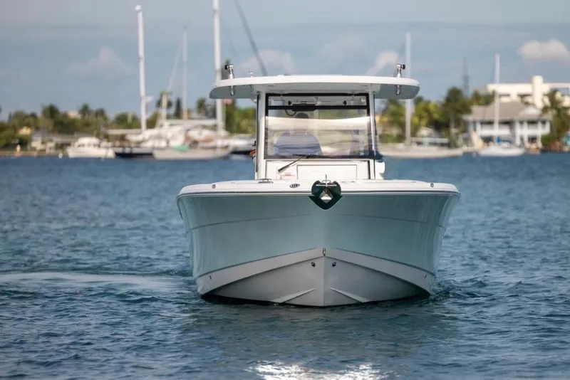 Slide: The Image of 2023 Robalo R302 Center Console boat cruising on calm waters. - 17