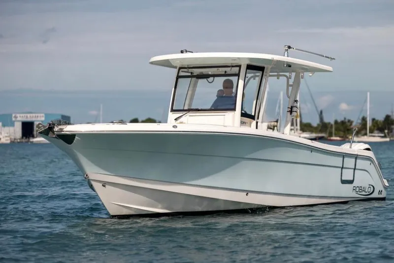Slide: The Image of 2023 Robalo R302 Center Console boat cruising on calm waters. - 18
