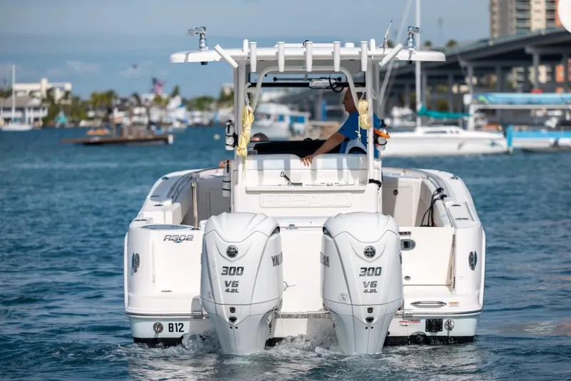 Slide: The Image of 2023 Robalo R302 Center Console boat with dual Yamaha 300 engines on the water. - 22