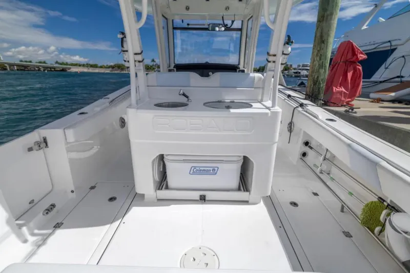 Slide: The Image of 2023 Robalo R302 Center Console boat interior with spacious deck and storage. - 25