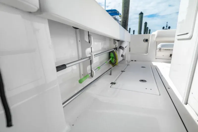 Slide: The Image of 2023 Robalo R302 Center Console boat interior with rod storage and clean deck design. - 26