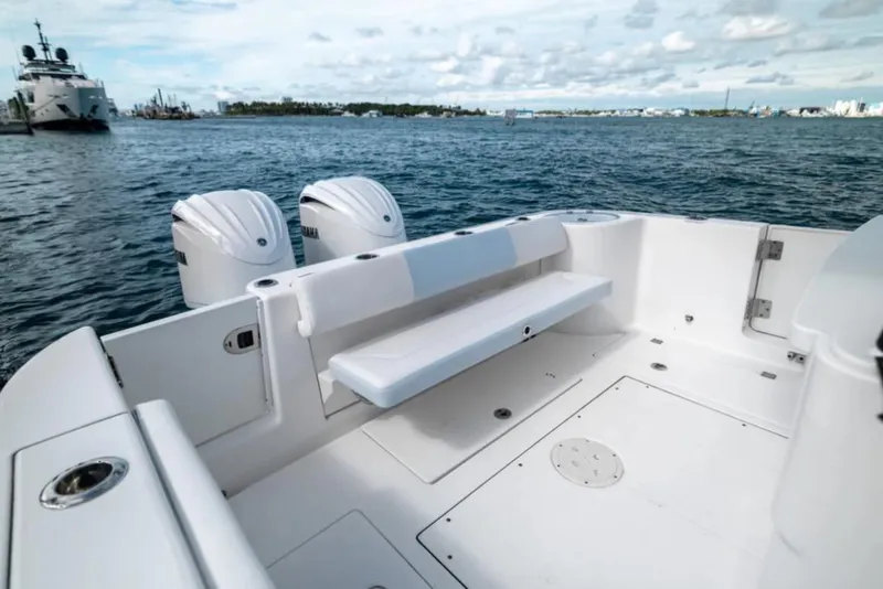 Slide: The Image of 2023 Robalo R302 Center Console boat with dual engines on calm water. - 27