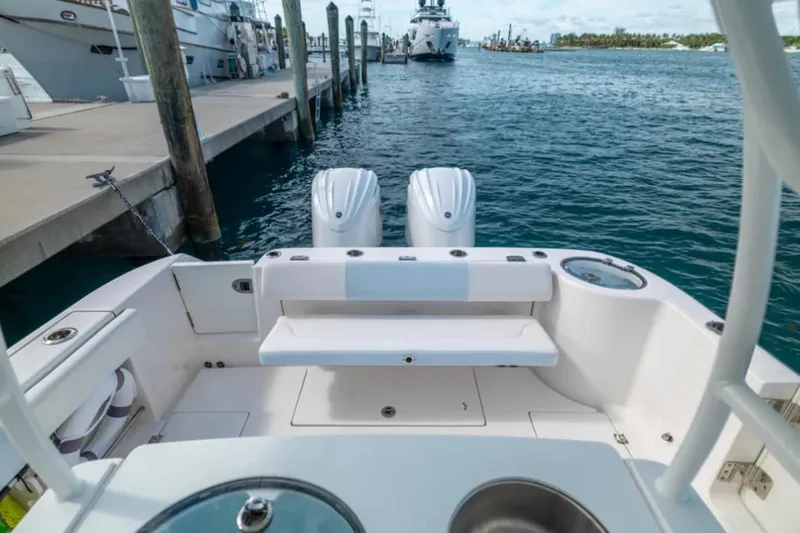 Slide: The Image of 2023 Robalo R302 Center Console boat docked, featuring dual engines and spacious deck. - 28
