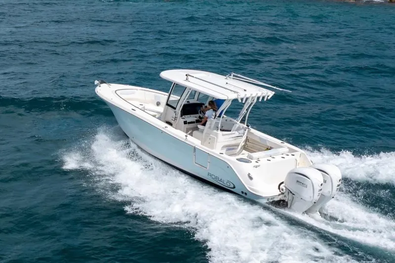 Slide: The Image of 2023 Robalo R302 Center Console boat cruising on open water. - 3