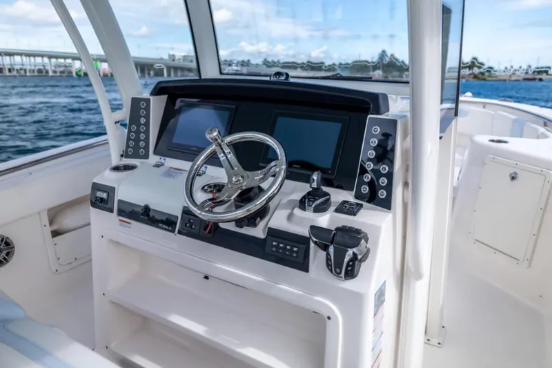 Slide: The Image of 2023 Robalo R302 Center Console boat helm with modern controls and dual displays. - 30