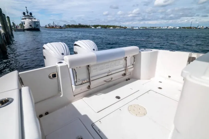 Slide: The Image of 2023 Robalo R302 Center Console boat with dual engines on a calm waterway. - 32