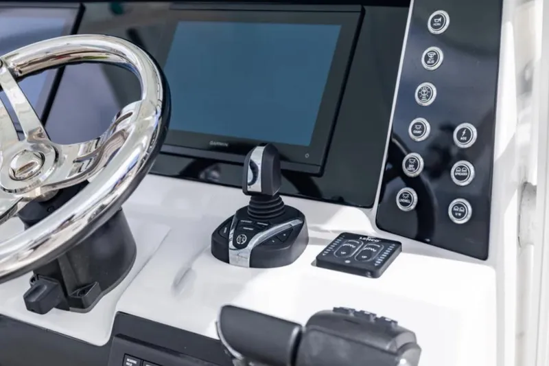 Slide: The Image of 2023 Robalo R302 Center Console helm with joystick and touchscreen controls. - 34