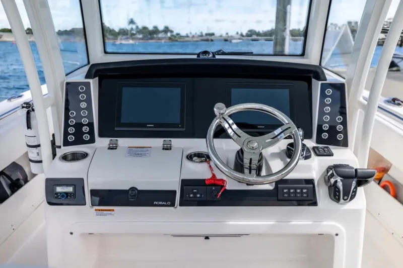 Slide: The Image of 2023 Robalo R302 Center Console helm with dual displays and modern controls. - 35