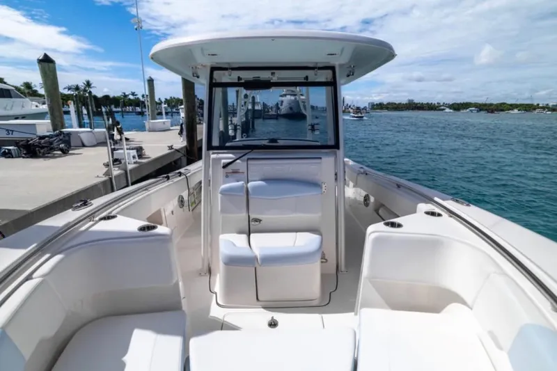 Slide: The Image of 2023 Robalo R302 Center Console boat docked by the marina, showcasing spacious seating. - 39