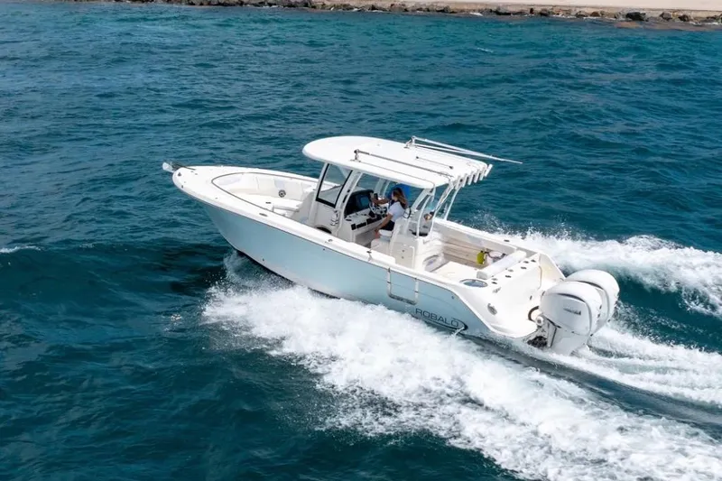 Slide: The Image of 2023 Robalo R302 Center Console boat cruising on open water. - 4