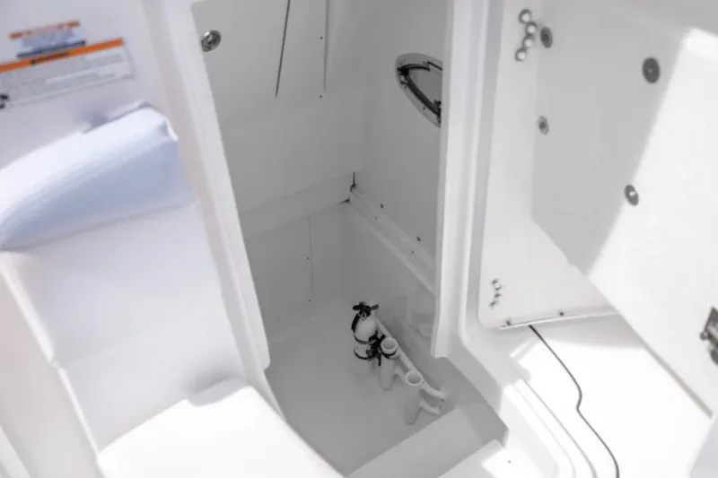 Slide: The Image of 2023 Robalo R302 Center Console interior storage compartment with open hatch. - 41
