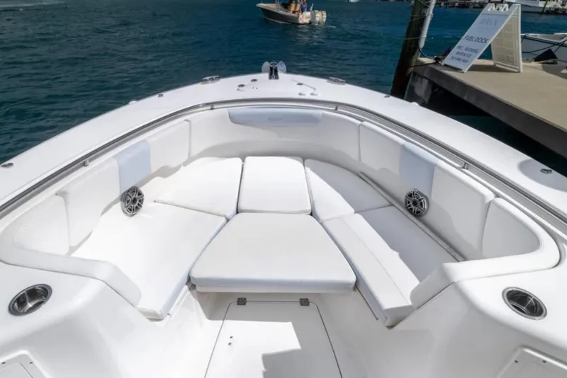 Slide: The Image of 2023 Robalo R302 Center Console boat with spacious seating area and ocean backdrop. - 43