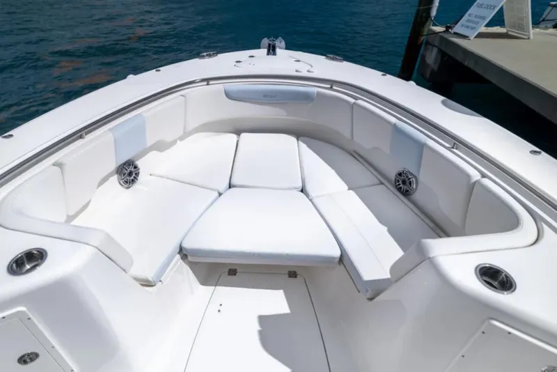 Slide: The Image of 2023 Robalo R302 Center Console boat with spacious white seating area. - 46