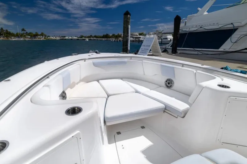 Slide: The Image of 2023 Robalo R302 Center Console boat interior with white seating and ocean view. - 48