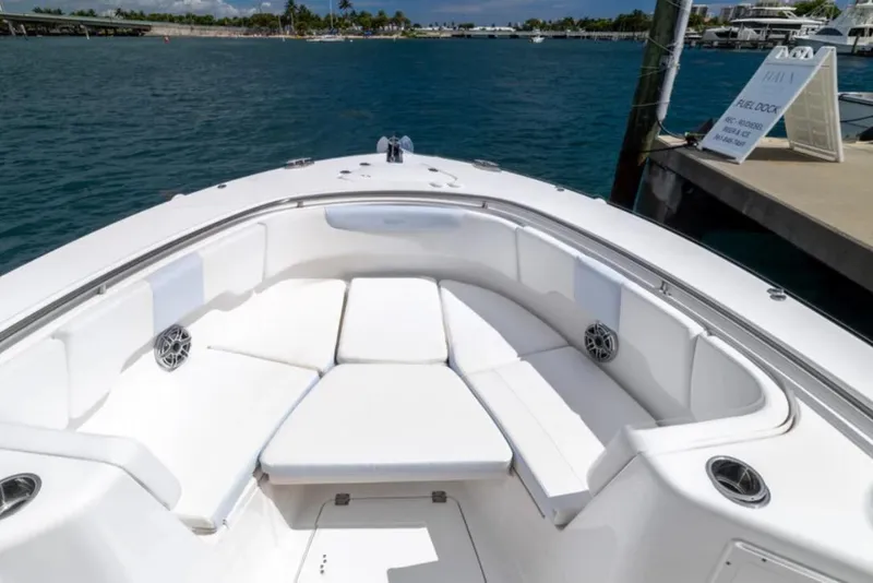 Slide: The Image of 2023 Robalo R302 Center Console boat with spacious seating at the dock. - 49