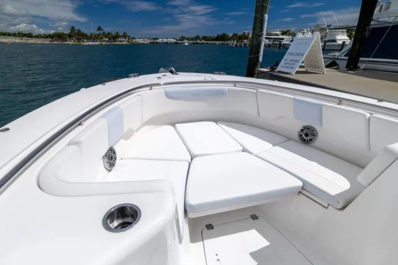 Slide: The Image of 2023 Robalo R302 Center Console boat with spacious seating, docked by the water. - 50