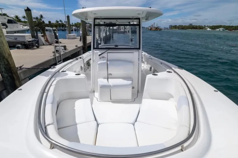 Slide: The Image of 2023 Robalo R302 Center Console boat with spacious seating, docked by the marina. - 51