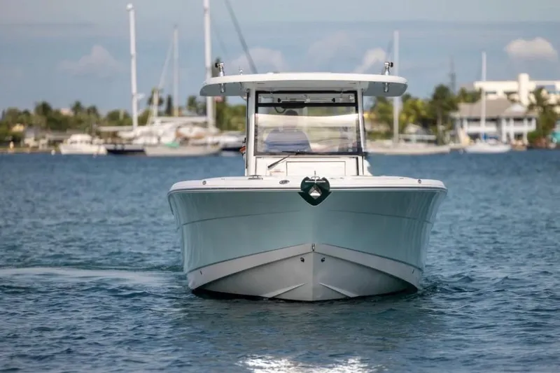 Slide: The Image of 2023 Robalo R302 Center Console boat on calm water, front view. - 8