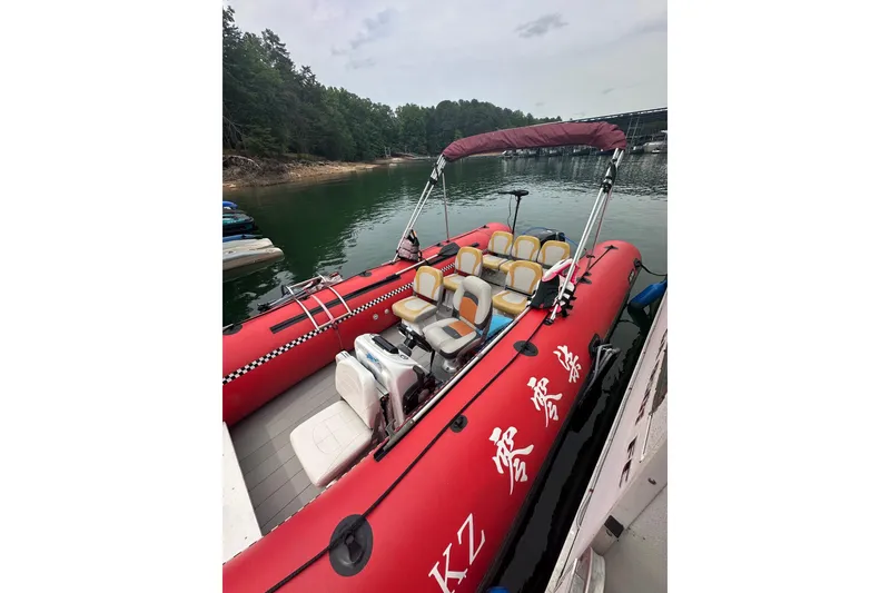 Slide: The Image of Red inflatable boat docked on a calm lake, surrounded by lush greenery. - 16