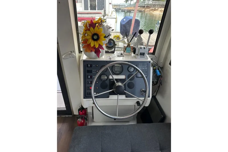 Slide: The Image of Helm of 1996 Catamaran Cruisers 12x42 with steering wheel and control panel. - 3